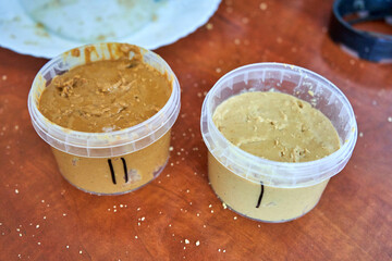 Two flavors cashew butter in plastic jars. 