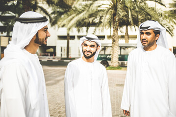 Wall Mural - Three arabic business men discussing and spending time in Dubai