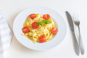 Wall Mural - Fresh Italian pasta with cherry tomatoes, cheese and basil. Vegetarian spaghetti. Healthy food.