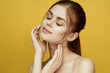 © VICHIZH - woman with bare shoulders clean skin hairstyle posing yellow background