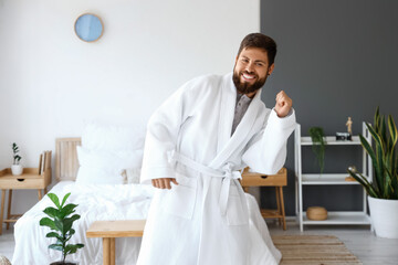 Sticker - Dancing young man wearing bathrobe in bedroom