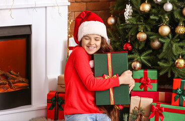 Poster - Cute little girl with gifts at home on Christmas eve