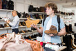 © JackF - Interested teenage boy visiting shoe shop in search of comfortable spring and autumn shoes .