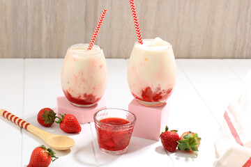 Wall Mural - Two Glass Fresh Korean Strawberry Milk with Homemade Strawberry Compote Sauce on White Background