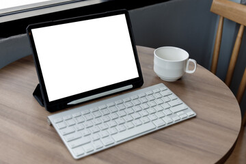 Poster - Blank screen laptop computer modern man use room laptop with blank white desktop screen with coffee cup on wooden table in cafe