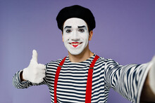 Close Up Young Mime Man With White Face Mask Wears Striped Shirt Beret Do Selfie Shot Pov On Mobile Phone Show Thumb Up Like Gesture Isolated On Plain Pastel Light Violet Background Studio Portrait.