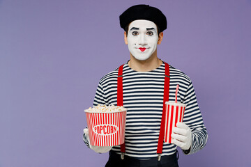 Wall Mural - Charismatic amazing marvelous vivid young mime man with white face mask wear striped shirt beret old bucket of popcorn cup of soda pop isolated on plain pastel light violet background studio portrait