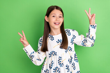 Wall Mural - Photo of positive energetic schoolkid make v-sign dancing spring school disco isolated over green color background