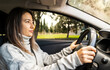 © vahit - Young woman driver wandering around rural neighborhood. Driving safety and enjoyment concept.