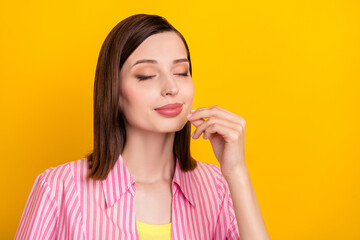 Poster - Photo of charming lovely lady closed eyed hand fingers make gourmet symbol isolated on yellow color background