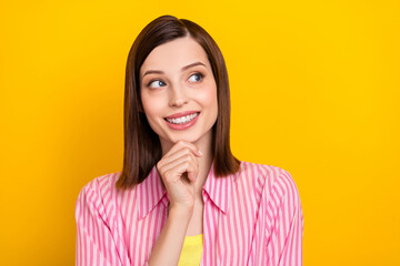 Wall Mural - Portrait of pretty satisfied lady hand touch chin look interested empty space isolated on yellow color background