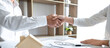 © Freedomz - Real estate agent and customers shaking hands together celebrating finished contract after signing about home insurance and investment loan, handshake and successful deal