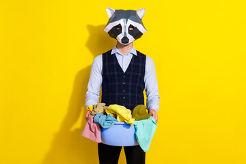 Poster - Photo of washer guy hold basin full clothes laundry ad wear raccoon mask vest isolated yellow color background