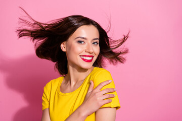 Wall Mural - Portrait of attractive carefree shine cheerful girl hugging herself throwing hair isolated over pink pastel color background