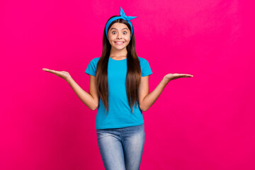 Canvas Print - Portrait of attractive trendy cheerful girl holding on palms copy space isolated over vivid pink magenta color background