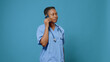 © DC Studio - Portrait of woman nurse in uniform talking on phone call, while having stethoscope. Healthcare specialist using mobile phone to give medical advice in studio. Assistant with smartphone