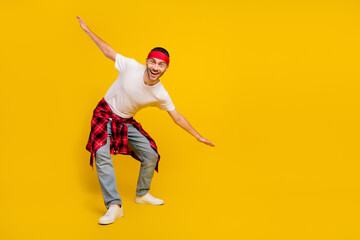 Sticker - Full size photo of cheerful man wear plaid shirt on waist summer hands wings isolated on yellow color background