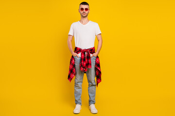 Canvas Print - Full length photo of serious young man wear plaid shirt tied on waist sunglass isolated on yellow color background