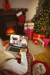 Sticker - Santa claus making laptop christmas group video call with smiling caucasian family and friends