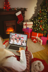 Poster - Santa claus making laptop christmas video call with smiling multi generation caucasian family