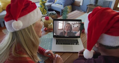 Sticker - Caucasian couple with santa hats using laptop for christmas video call with woman on screen