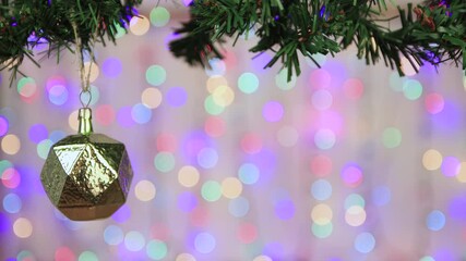 vintage christmas ball on a branch, copy space. close-up of a decoration with colored christmas ligh