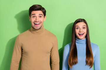 Poster - Photo of two astonished funny people open mouth look camera isolated on green color background