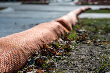 selective focus on filter sock around exposed dirt at a construction site to prevent stormwater erosion and runoff 