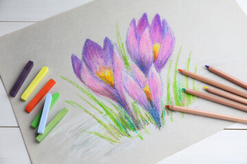 Sticker - Colorful chalk pastels, pencils and beautiful painting of crocus flowers on white wooden table, above view