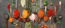 Various Spices And Herbs In A Spoon. Dark Grunge Background. Top View, Flat Lay. Banner