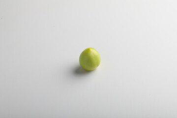 Wall Mural - green tomato on white background.