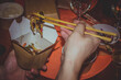 Vietnamese noodles wok and khasi sticks in hand