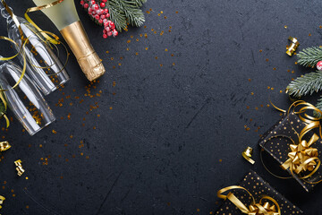 Wall Mural - Holiday gift box or present with ribbon, golden confetti and gold baubles on black background. Magic christmas greeting card. Christmas Decoration. Border design. Mock up. Top view.