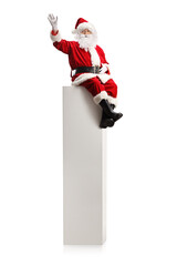 Santa claus sitting on a tall white column and waving