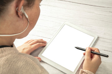 Young creative digital artist working with graphic tablet with pen in hands of young woman isolated white background for copy space. top view