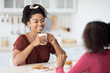 © Prostock-studio - Pretty black woman drinking tea with her daughter