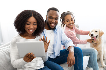 Poster - Black family having video conference using digital tablet waving hands