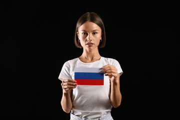 Poster - Beautiful young woman with flag of Russia on dark background