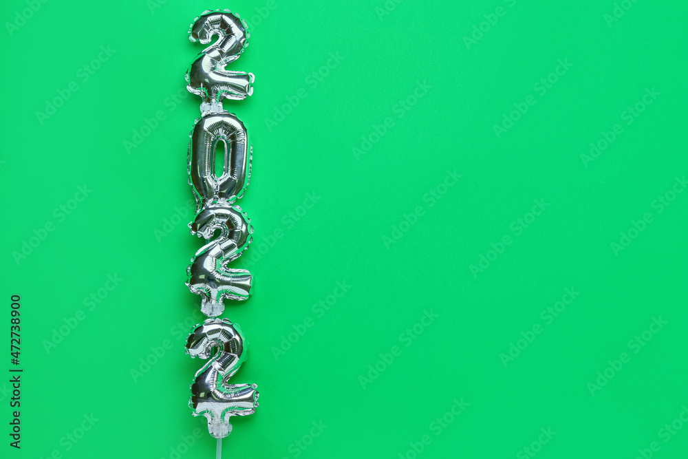 Figure 2022 made of silver balloons on green background
