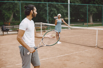 Two tennis players with rackets in hands during the match