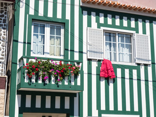 Poster - Portugal, Costa Nova. Colorful houses Palheiros striped homes