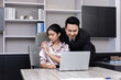 © jayzynism - A Boss touching the shoulder of employee colleague in workplace at office.