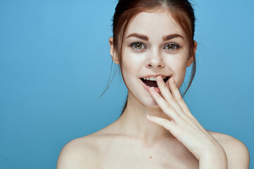 Wall Mural - woman with bared shoulders pigtail emotions posing blue background