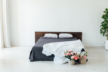 Canvas Print - interior of a white bedroom with a bed and flowers