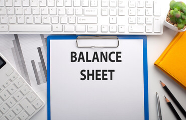 Poster - BALANCE SHEET written on the paper with keyboard, chart, calculator and notebook