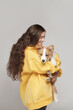 Young woman hugs a puppy. Border Collie breed. Studio photography.