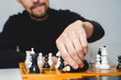 © Вячеслав Краснов - Man wearing beard playing chess on board. Strategy and competition concept. Selective focus
