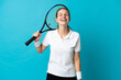© luismolinero - Young woman tennis player isolated on blue background laughing