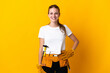 © luismolinero - Young electrician woman isolated on yellow background laughing