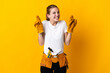 © luismolinero - Young electrician woman isolated on yellow background with fingers crossing